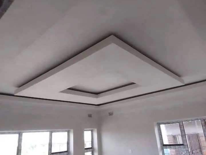 Stepped white bulkhead ceiling in a living room