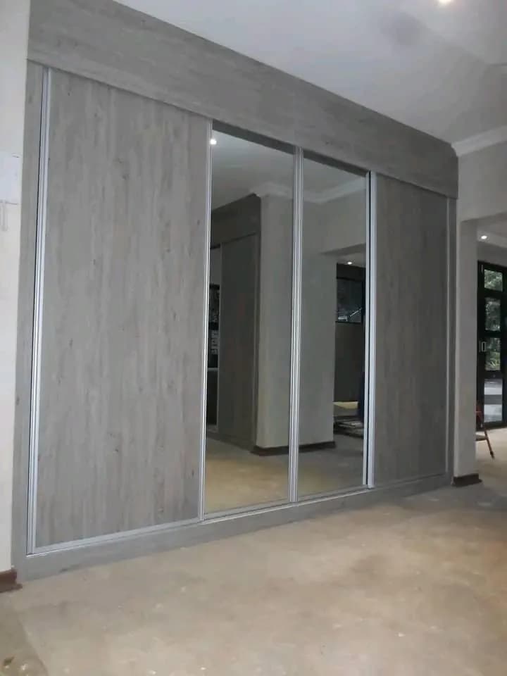 Sliding wardrobe with woodgrain and mirrored door panels
